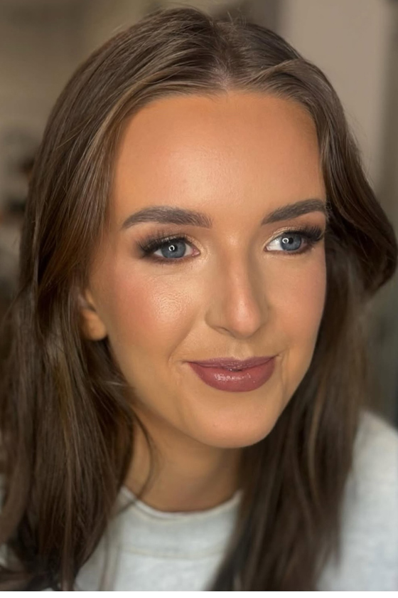 Smiling girl with blushed cheeks and bronzed complexion